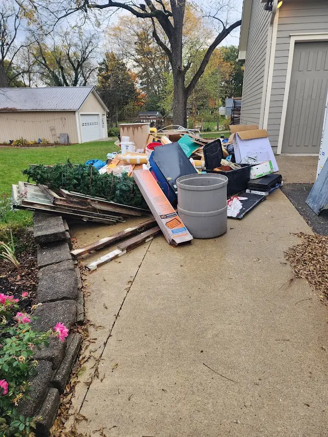 Dumpster being loaded with debris for Estate Cleanout Dumpster Rental in Westlake Village